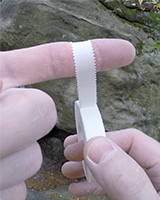 Taping finger with serrated edge tape.