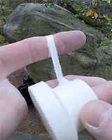 Ripping a wide tape to get a thin strip.